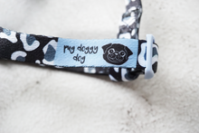 Load image into Gallery viewer, black and white leopard print dog strap harness with blue logo