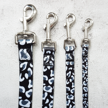 Load image into Gallery viewer, 4 sizes of black and white leopard print dog leads with silver lobster clasp